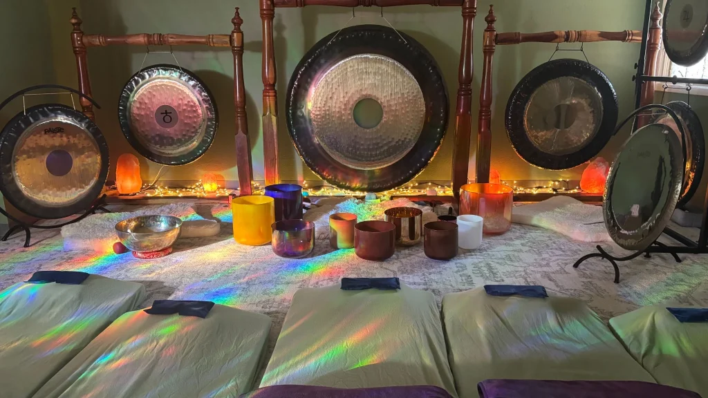 Sound healing room at Sedona Crystal Temple with crystal singing bowls, cushioned beds and large Paiste gongs